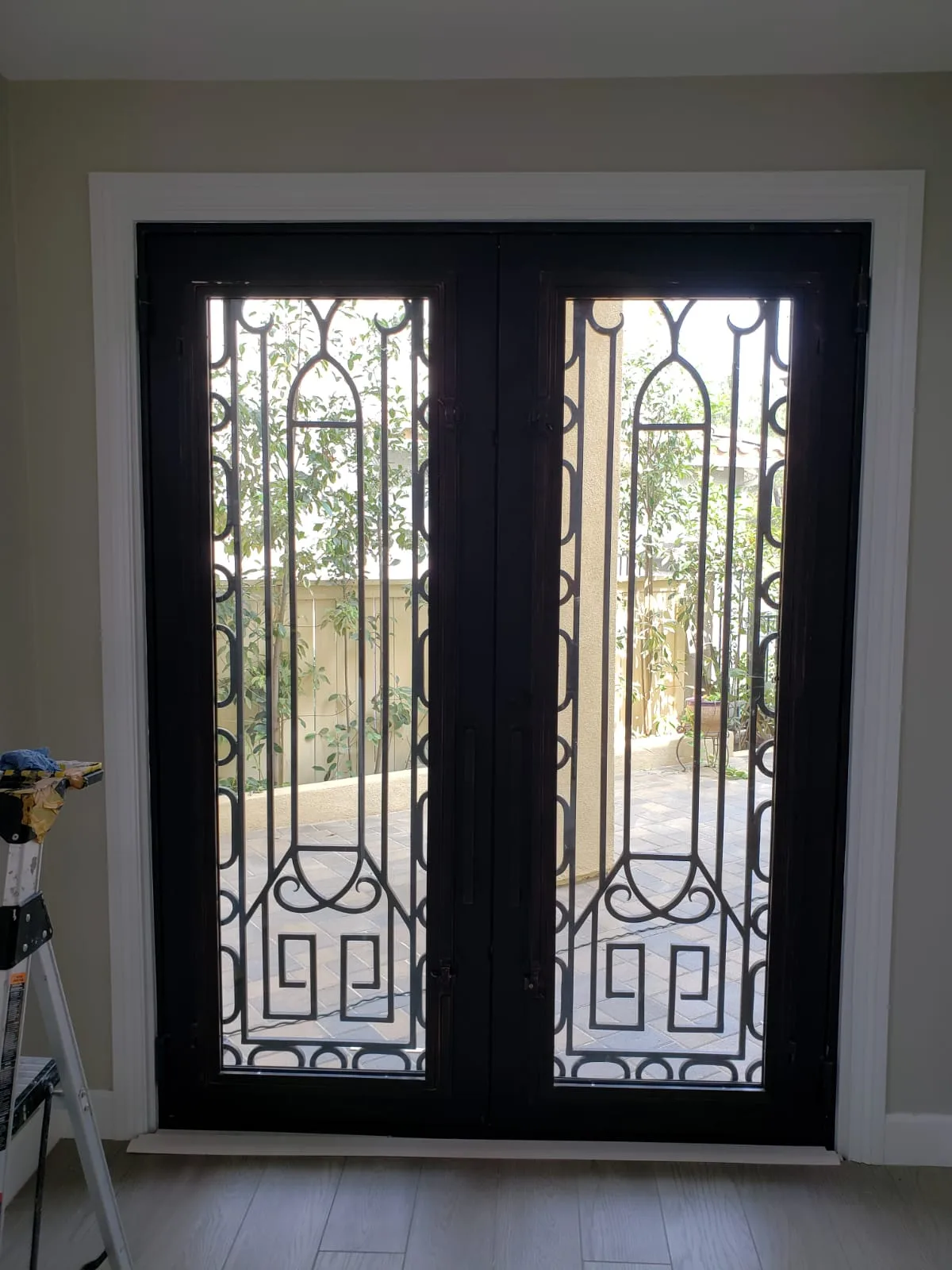 Interior black iron double doors with geometric grille and clear glass