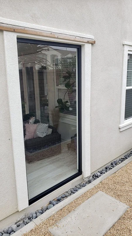 Slim black framed glass window wall on a home exterior
